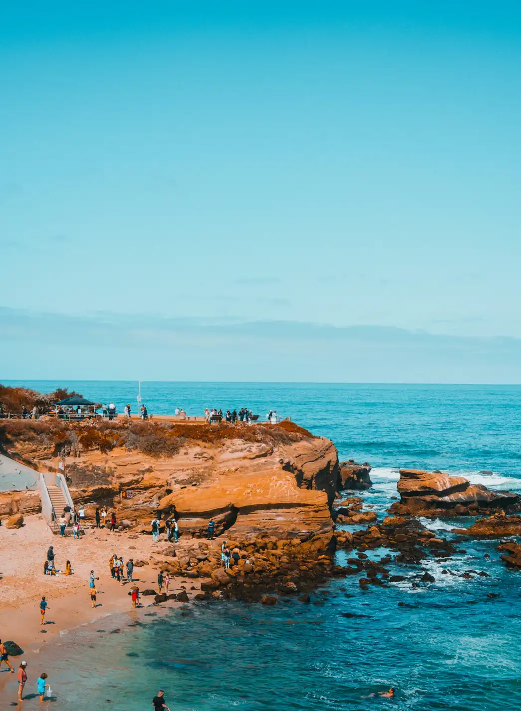 picture of people standing on rocks at the beach